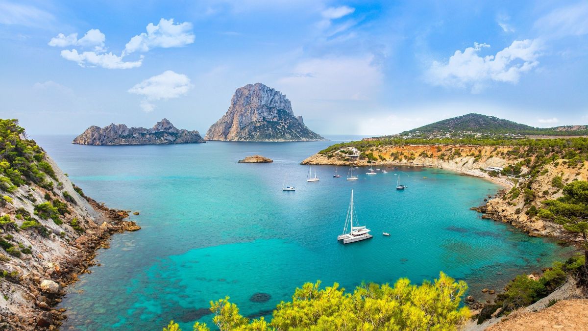 Ocean view with a peaceful boat you can experience on a luxury holiday North Ibiza.