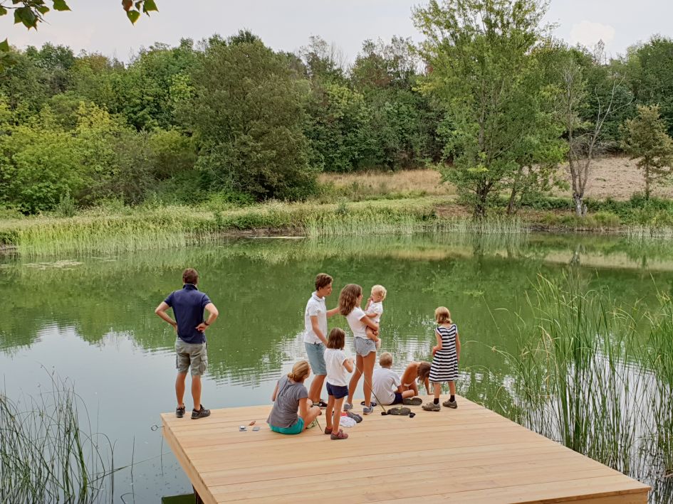 A family enjoying their luxury villa holiday in Umbria by the private lake on The Murlo Estate 