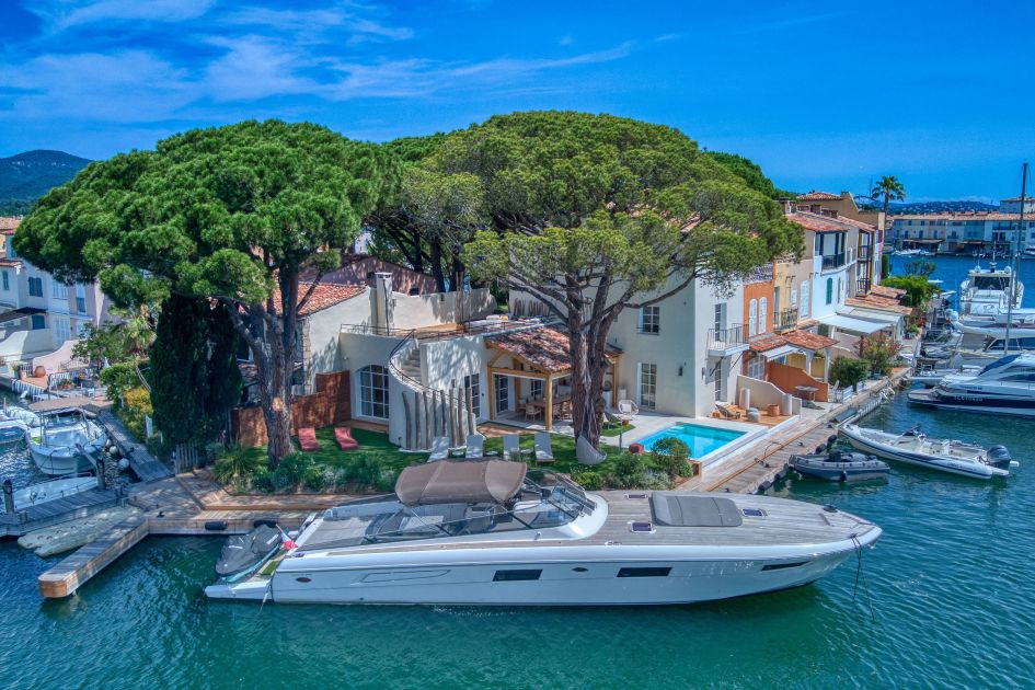 View of Villa My World, with a close up of the villa's private mooring and boat.