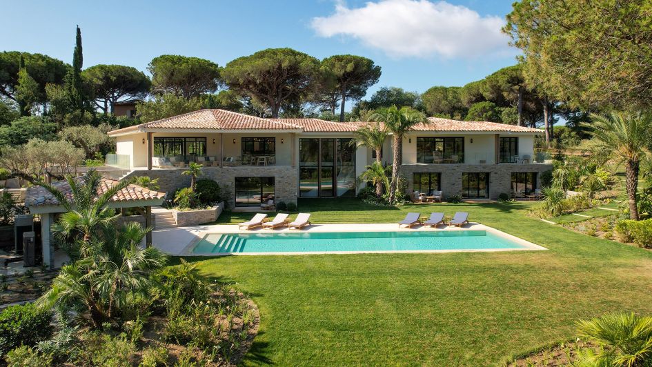 Exterior of luxury Villa B in St Tropez, showing the outdoor swimming pool and garden area.