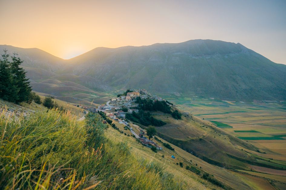 View over the green valleys surrounding Castelluccio di Norcia in Umbria. This is a hidden gem to discover during Italy summer holidays.