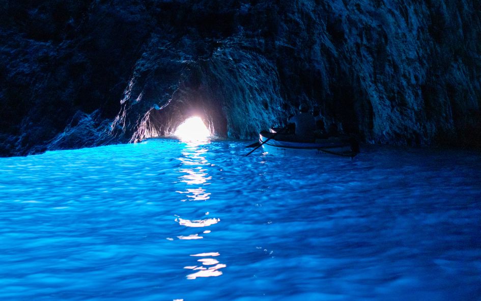 Shiny blue waters inside the Blue Grotto (Grotta Azzurra) in Anacapri. A great place to visit on a luxury holiday in Capri.