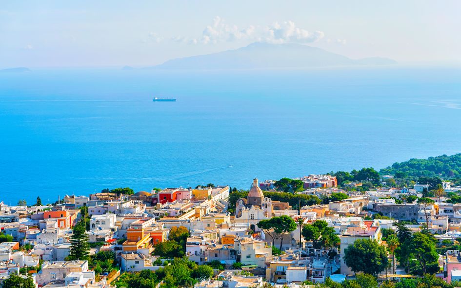 Aerial view over Capri houses with the Mediterranean Sea in the background.