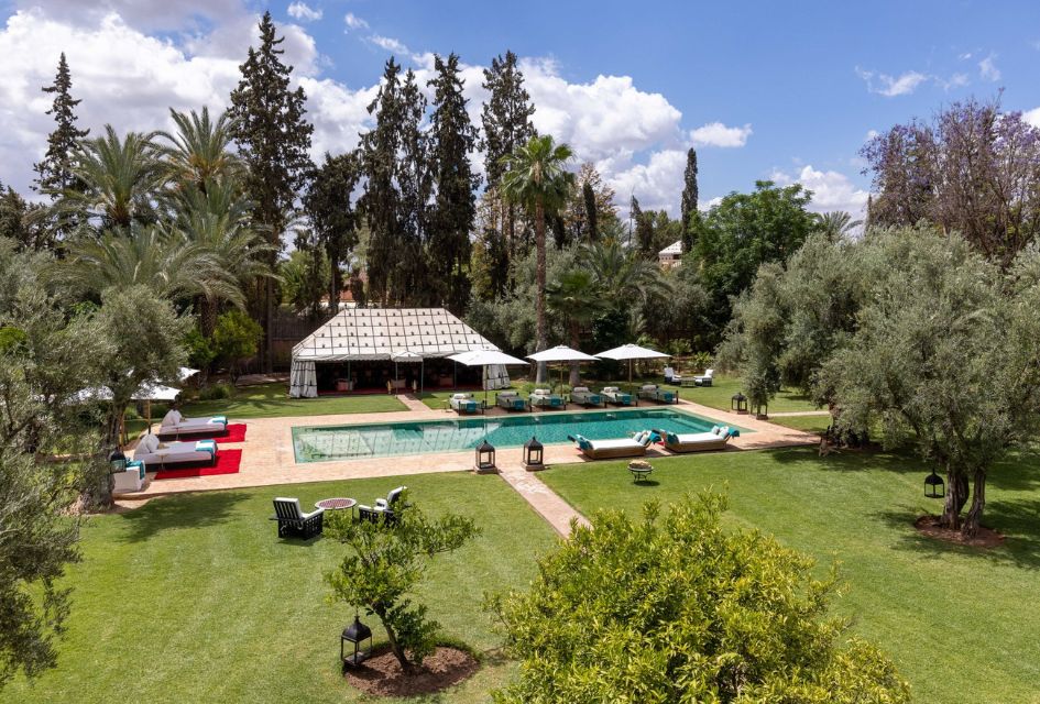 Villa Ezzahra, Marrakech, Morocco View over the outdoor swimming pool of Villa Ezzahra surrounded by the lush gardens of the Ezzahra Estate, one of the best villa estates in Morocoo.