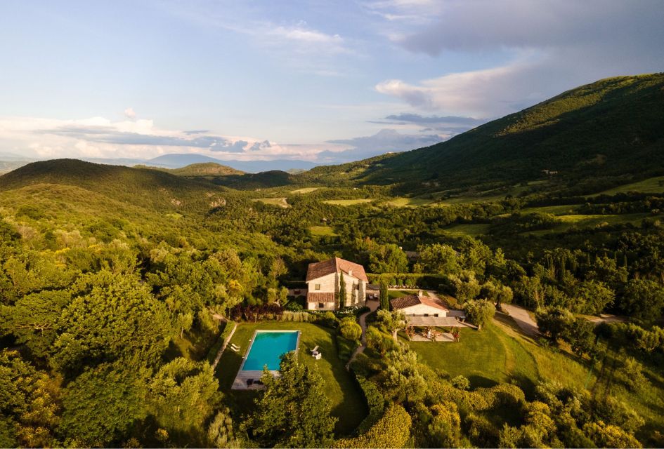 Villa Caminata, The Murlo Estate, Umbria, Italy Drone shot over Villa Caminata surrounded by the lush green valleys of the Murlo Esate