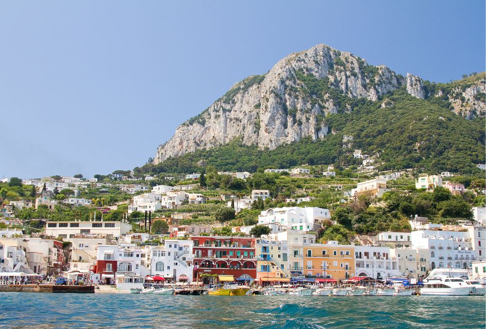 Capri. Credit: Roger De Marfà via Canva Free Photos The boat-lined shore of Capri with its colourful houses and tall hills behind it, the perfect movie set to visit.