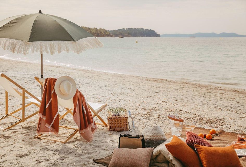 Villa Clos Mireille, Provence - beach access. The private beach access from Villa Clos Mireille in Provence, with a picnic, parasol, loungers, and wine. The perfect set jetting destination to take in the view of the sea.