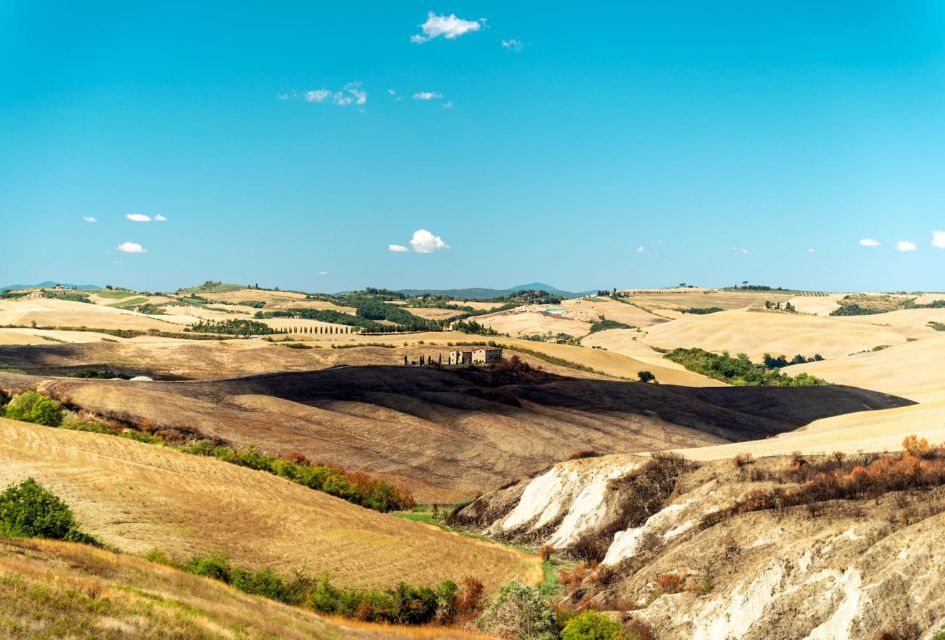 Tuscany. Copyright: ENIT - Agenzia Nazionale del Turismo Rolling hills of Tuscany with bright blue skies and sparsely spread Italian buildings.