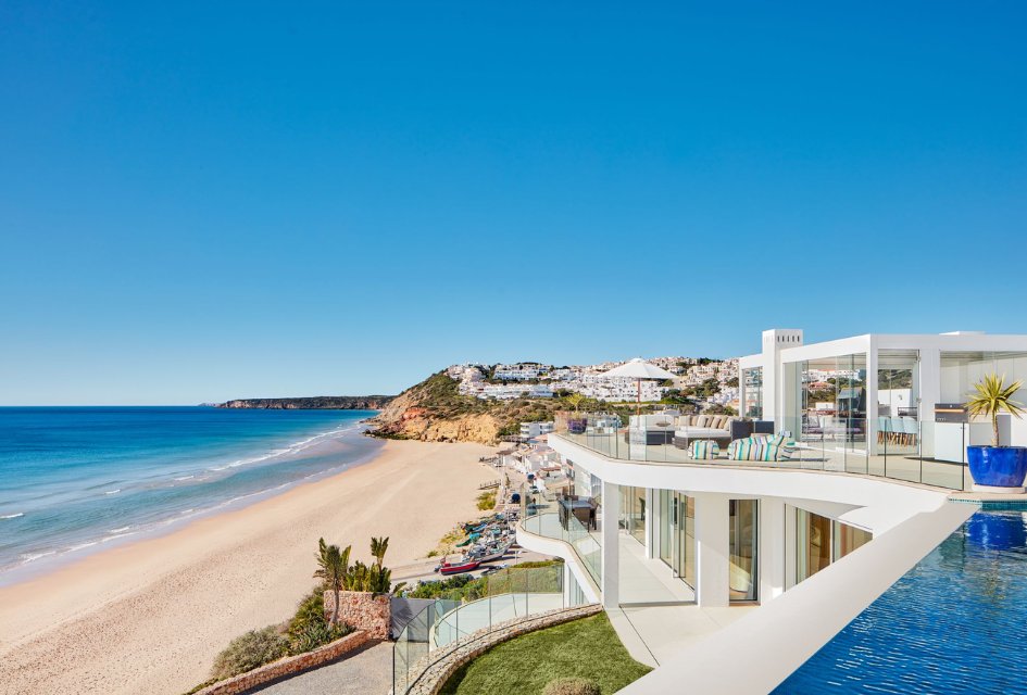Villa Alegria, Algarve A view of Salema Beach from the infinity pool at Villa Alegria one of the best luxury villas for Algarve holidays with direct beach access.