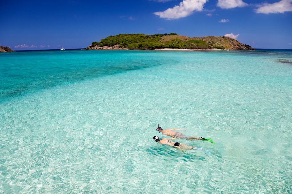Couple snorkelling in the Caribbean © cdwheatley via Canva.com Couple snorkelling in light azure waters in the Caribbean - one of the top places to snorkel in the world thanks to its array of tropical fish, natural beauty and barefoot luxury appeal!