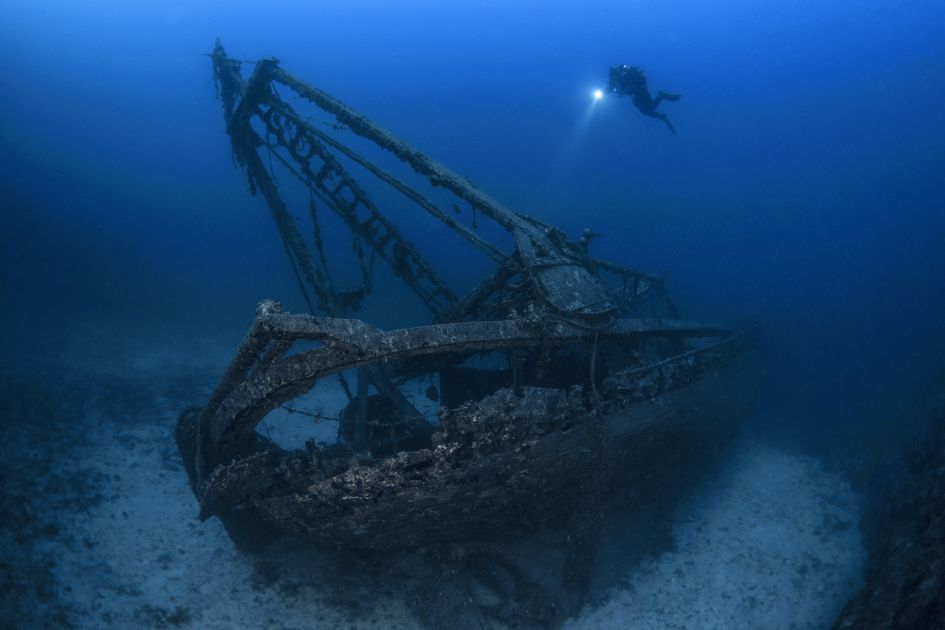 'Fortunal' Shipwreck found off Vis Islands, Croatia © Damir Zurub Snorkeller with a flashlight exploring the 'Fortuna' shipwreck in dark blue waters. Located just off the coast of Vis Island, it's just one of many reasons why Croatia joins our list of the best places to snorkel in the world.