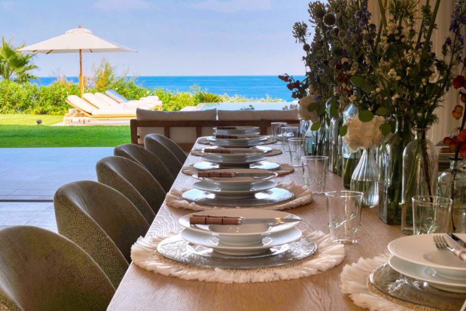 Sea views seen from Villa Las Brisas' indoor dining table, set up with cutlery and crockery ready for meals to be enjoyed.