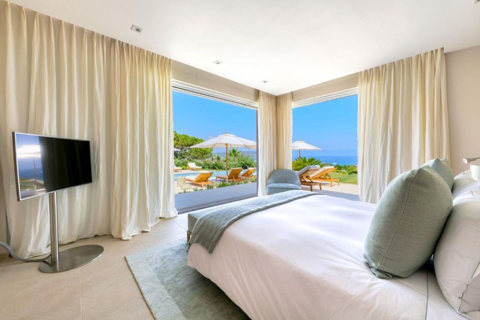 One of Villa Las Brisas' sumptuous bedrooms, complete with ambient lighting and a cosy atmosphere, ready for a night's rest.