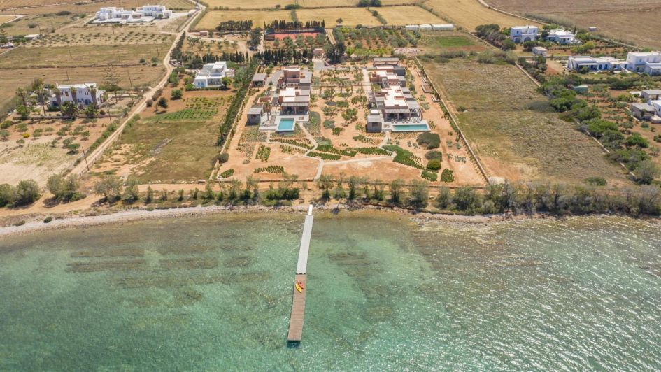 An aerial shot of Dumaresq Estate's two property buildings and surrounding gardens, which lead down to a very own private jetty on the Aegean waters.
