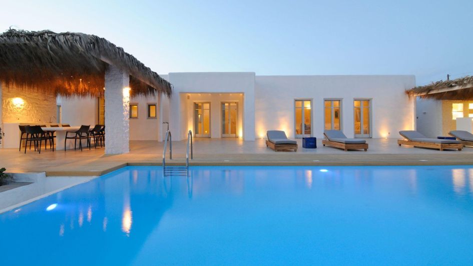 The Golden Beach House exhibits classic Cycladic architecture and shaded pergolas, that sit behind the beautifully inviting outdoor pool.