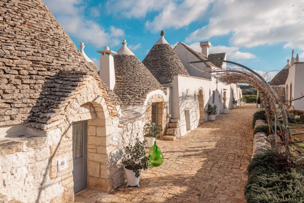 Masseria Le Monache, Puglia Domed trulli rooftops and an historic cobbled path of Masseria Le Monache, Puglia