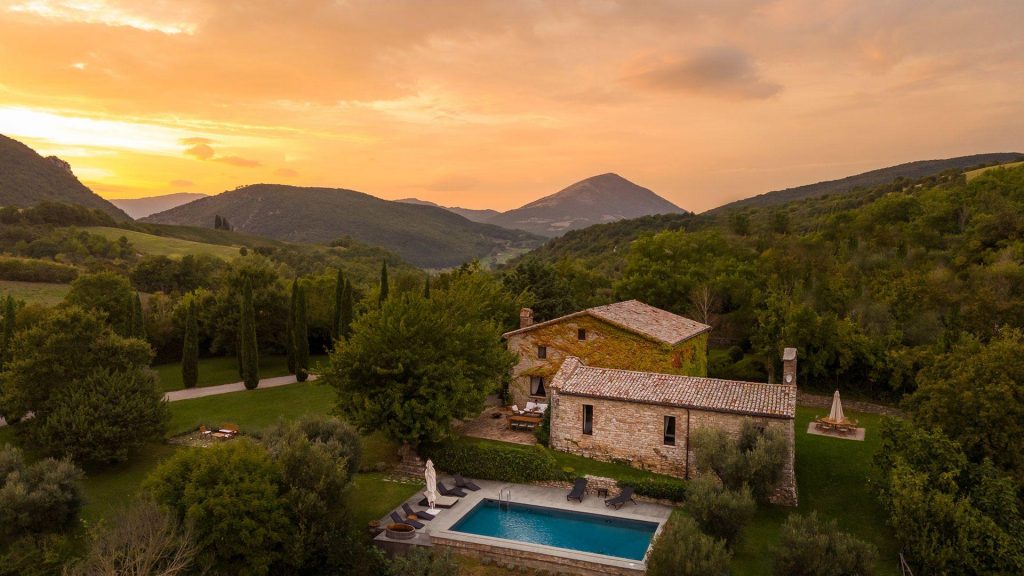 Villa San Savina, Umbria Sunset views of luxury villa rental San Savino with outdoor swimming pool in the foreground, with Umbrian hills and courtryside in the distance.