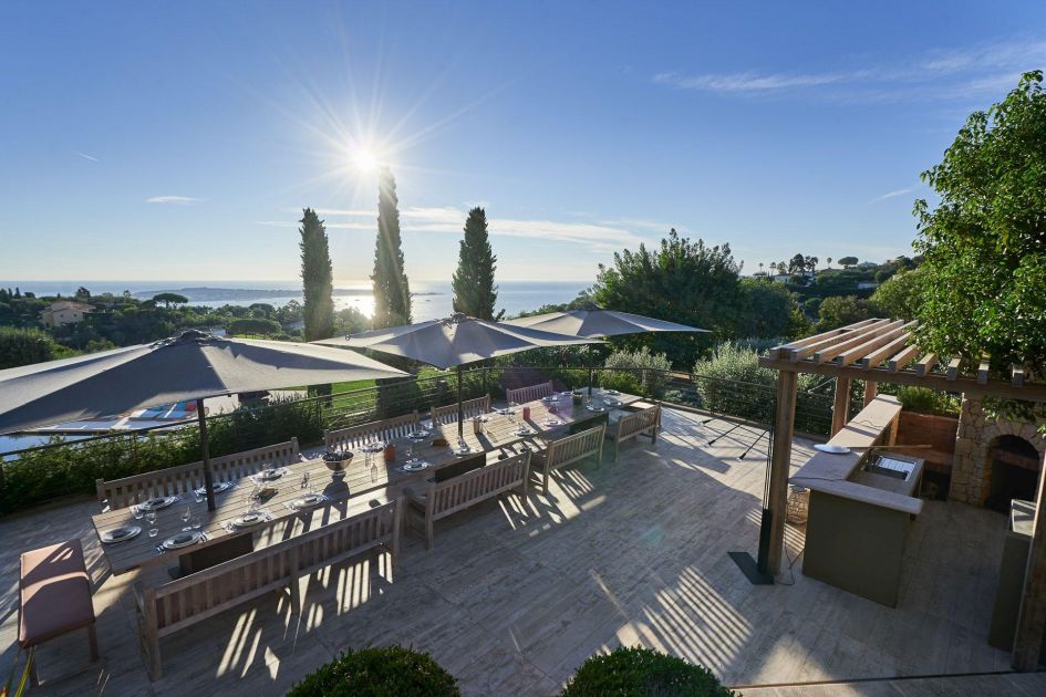 Sunset and sea views seen from one of many alfresco dining terraces at Domaine de L'Ansa in Cannes - one of our top 5 ultimate luxury catered villas - for a holiday in the South of France.