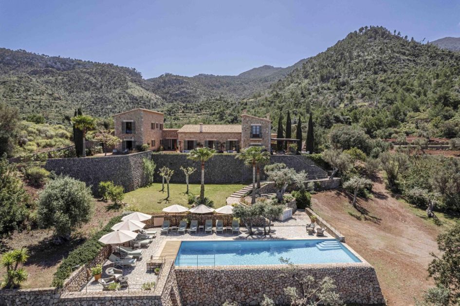 Villa Sa Terra Rotja, Mallorca Traditional architecture sets the scene as a pathway leads down towards a serene swimming pool with poolside loungers to spend the idle hours of the day.