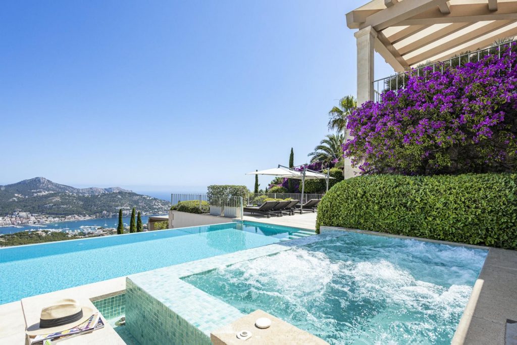 Finca Finesse, Mallorca The azure waters of the bubbling hot tub and infinity pool match the clear skies and distant sea views at Finca Finesse.