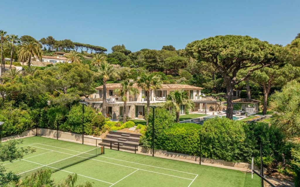 Villa Le Faune, Saint-Tropez Villa Le Faune showcases the finest of French Riviera luxury living, thanks to an outdoor tennis court (at the forefront of this photo), swimming pool behind, luscious gardens and an incredible 16-person villa that holds additional relaxing wellness amenities.