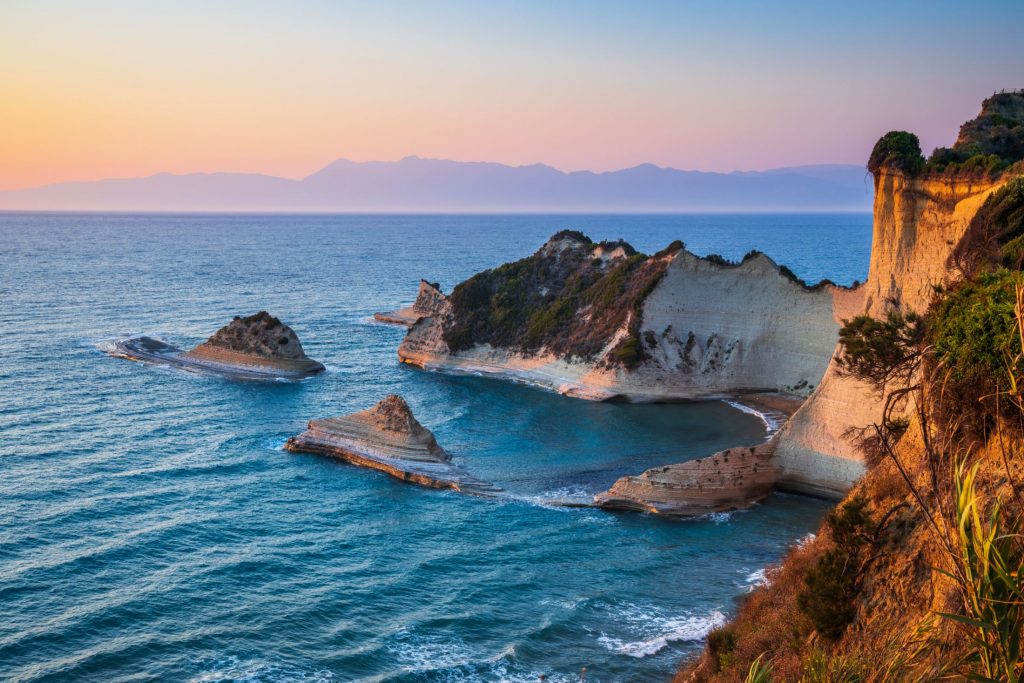 Corfu, Greece. Copyright - SCStock @ canva.com Looking out to the sea and cliffs from Corfu's coastline. Many people believe the island is that of Scheria in Homer's original 'The Odyssey' poem with Odysseus being washed up on Paleokastritsa Beach.