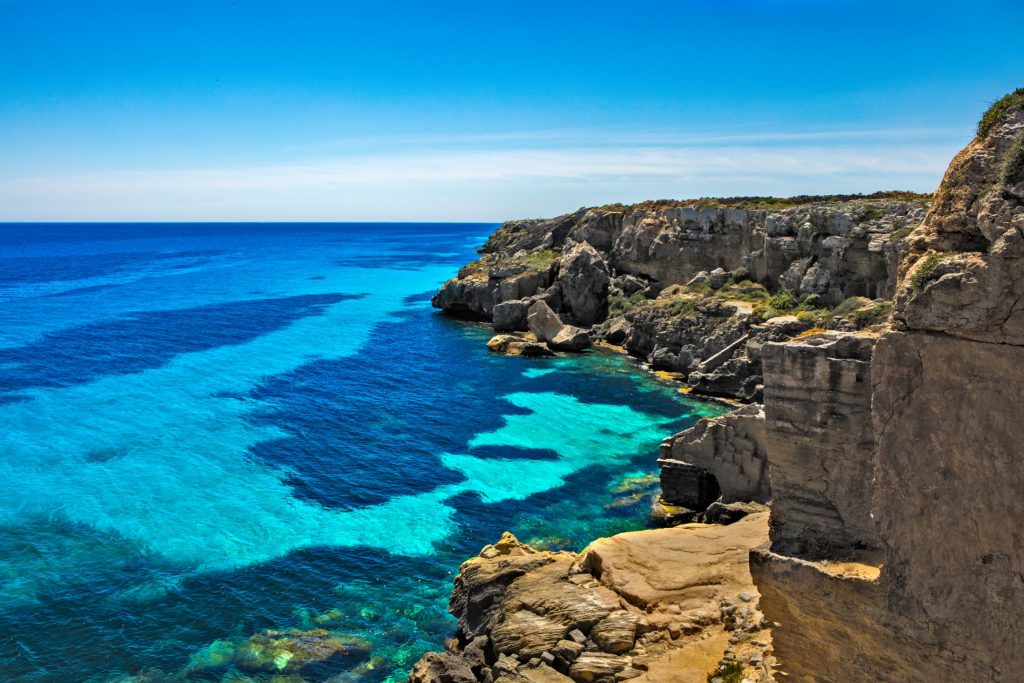 Island of Favignana. Copyright - iacona @ canva.com The Island of Favignana in Italy has starred as one of The Odyssey's filming locations and it is truly a beautiful setting, featuring sprawling cliffsides and a mosaic of azure blue water.