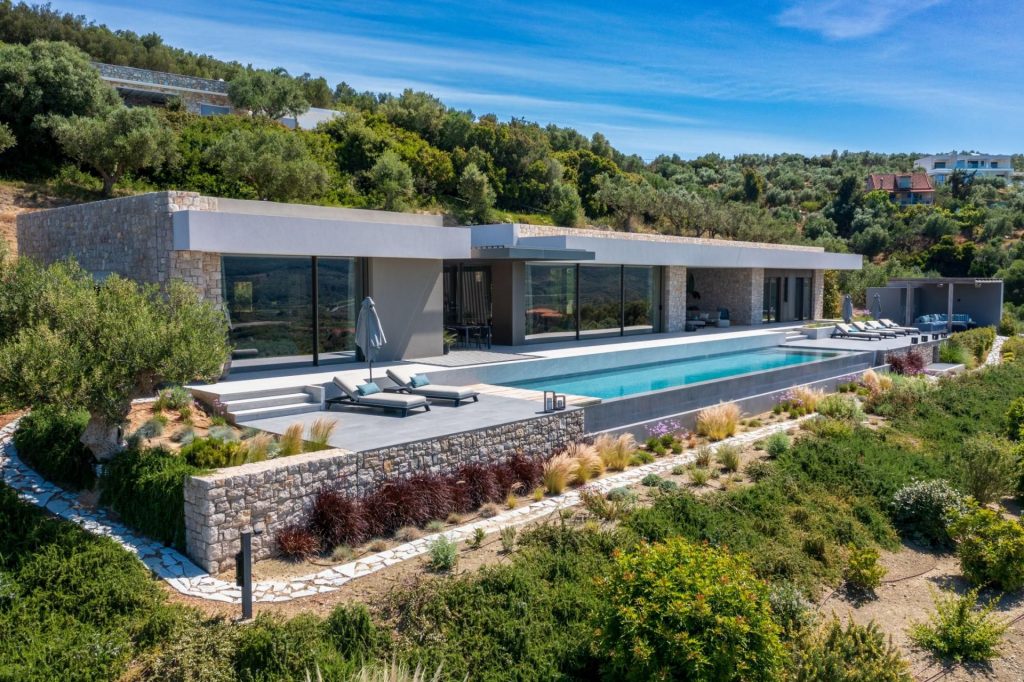 Villa Charlotte, Peloponnese Exterior shot of Villa Charlotte in the Peloponnese region of Greece. Showcasing its expansive terrace and large swimming pool, the villa sits within a 20-minute drive from one of The Odyssey filming locations.